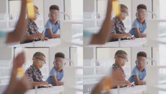 化学课上快乐的非裔美国男孩戴眼镜的视频高清在线视频素材下载