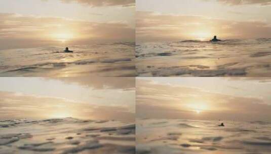 日出时分冲浪者游向海洋波浪海浪翻滚高清在线视频素材下载
