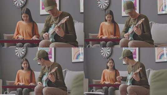 两位音乐家在家里演奏吉他和合成器高清在线视频素材下载