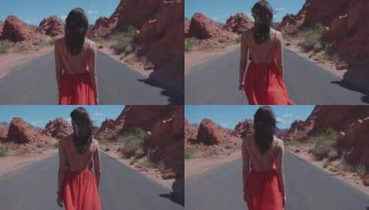 女人穿着红色太阳裙走在公路上高清在线视频素材下载