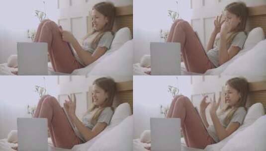 女孩在家里用笔记电脑视频通话高清在线视频素材下载