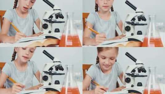 女孩在显微镜前写东西高清在线视频素材下载