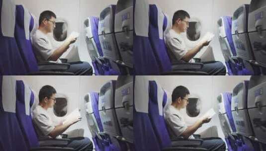 男子在飞机上看书学习高清在线视频素材下载