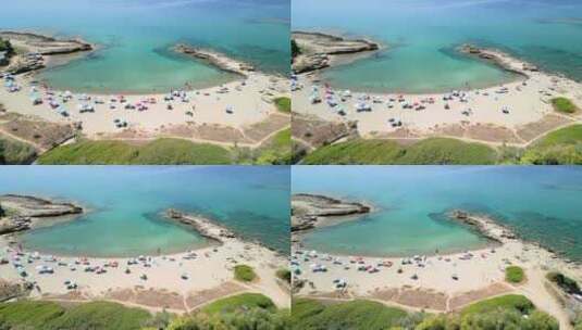 意大利撒丁岛上岩石间的白色沙滩和蓝绿色海水高清在线视频素材下载