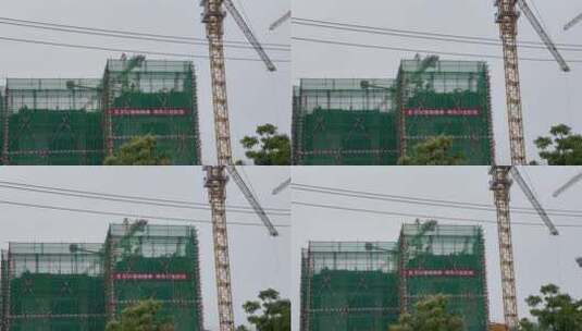 建筑工地安全帽施工的工人塔吊高清在线视频素材下载