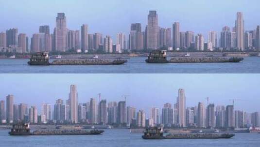 武汉江面上行驶的货船 城市高楼大厦背景高清在线视频素材下载