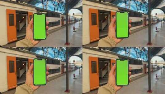 乘客在站台背景上手持带有绿屏模拟的手机前高清在线视频素材下载