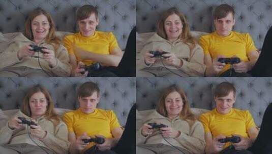夫妇躺在床上玩游戏高清在线视频素材下载