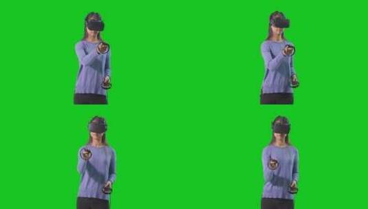 女人在绿色背景玩虚拟游戏高清在线视频素材下载