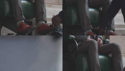 男人坐在真皮沙发上擦皮鞋高清在线视频素材下载