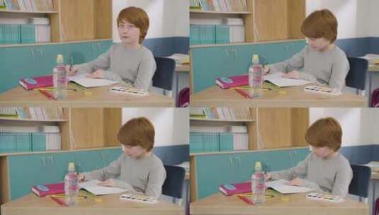 男孩坐在书桌前学习高清在线视频素材下载