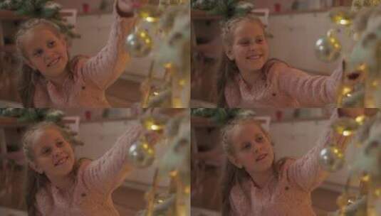 小女孩在家用球装饰圣诞树高清在线视频素材下载