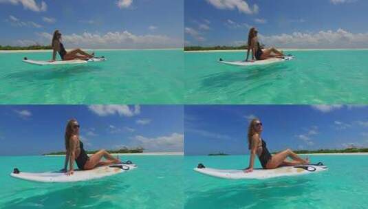 女孩坐在冲浪板上高清在线视频素材下载