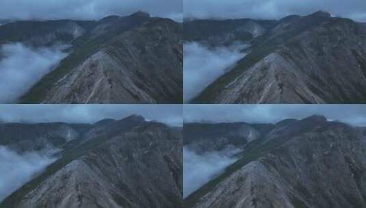 航拍四川甘孜稻城亚丁云雾缭绕的山脉景观高清在线视频素材下载