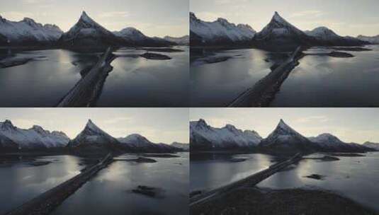 道路穿过冰湖，背景是白雪覆盖的山脉高清在线视频素材下载