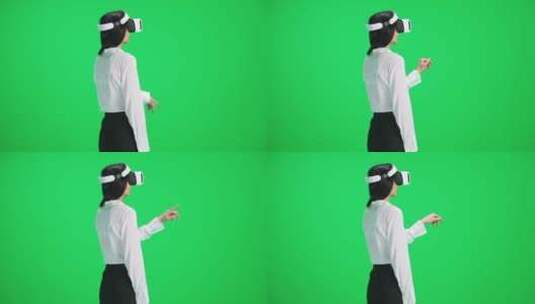 绿幕背景前女人在体验VR技术高清在线视频素材下载