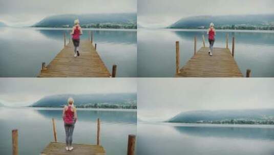女人在奥地利阿尔卑斯山风景如画的山湖附近晨跑高清在线视频素材下载