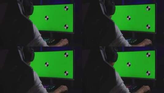 游戏玩家坐在绿幕凹形屏幕电脑前高清在线视频素材下载