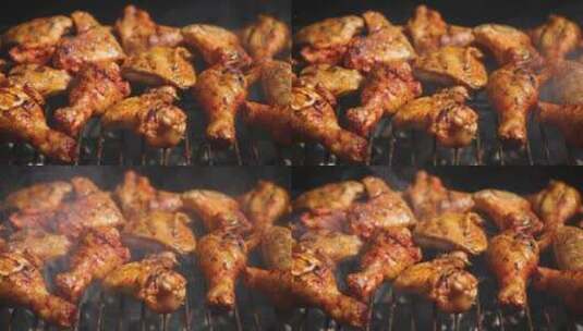 烧烤架上的鸡腿和鸡翅特写高清在线视频素材下载