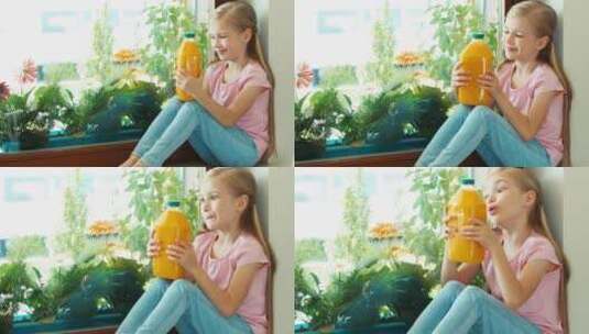 女孩拿着橙汁坐在窗台旁高清在线视频素材下载
