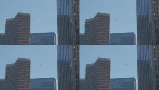 飞机飞过城市大楼高清在线视频素材下载