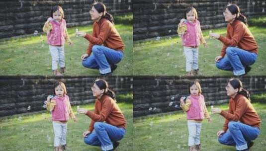 小朋友和妈妈在秋天公园里玩耍吹泡泡高清在线视频素材下载
