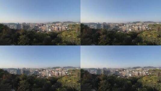 蓝天和夕阳下被森林环绕的城市高清在线视频素材下载