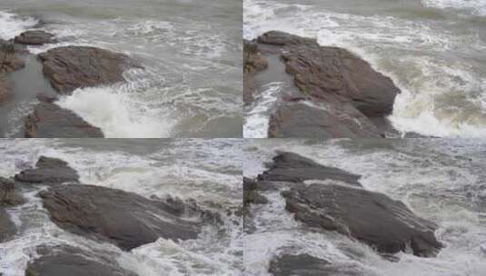 海浪拍打岩石浑浊海水冲刷礁石浪花阴天大海高清在线视频素材下载