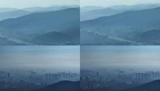 航拍雾霾里的城市和山脉高清在线视频素材下载