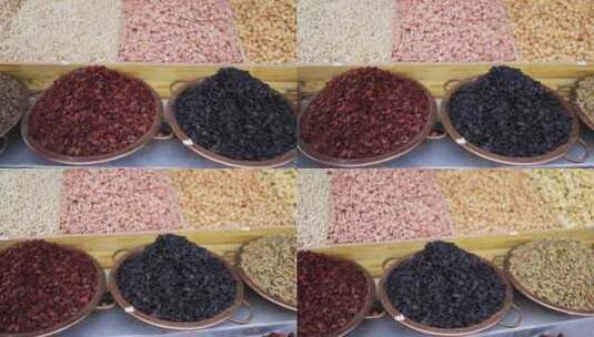 市场上待售的摊货新疆特产坚果葡萄干高清在线视频素材下载