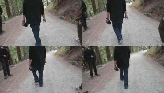 男人拿着水在森林小路上行走高清在线视频素材下载