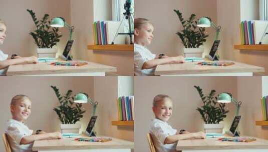 女孩坐在书桌前对着镜头微笑高清在线视频素材下载