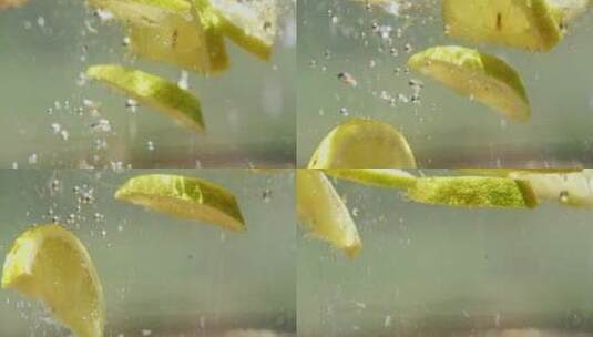 切片柠檬放入水中的特写镜头高清在线视频素材下载
