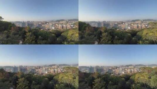 蓝天和夕阳下被森林环绕的城市高清在线视频素材下载