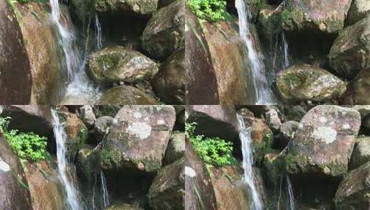 山林里顺岩石而下的瀑布泉水高清在线视频素材下载
