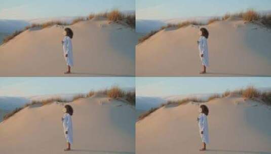 女演员用白花夏日摆沙子沙漠的姿势高清在线视频素材下载