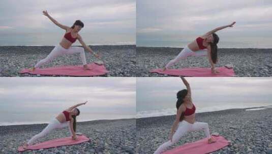 白天，女士在圆石滩的海边通过瑜伽体式训练身体高清在线视频素材下载