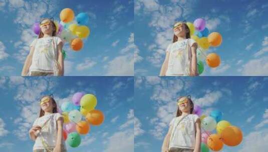 蓝天的小女孩玩耍五彩气球高清在线视频素材下载