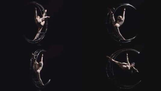 体操运动员在垂直弦中的金属结构月球上旋转高清在线视频素材下载