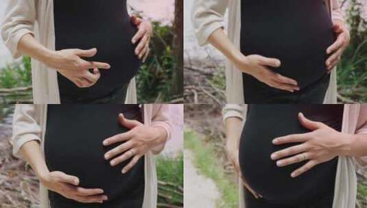 孕妇手轻轻触摸腹部的特写镜头高清在线视频素材下载
