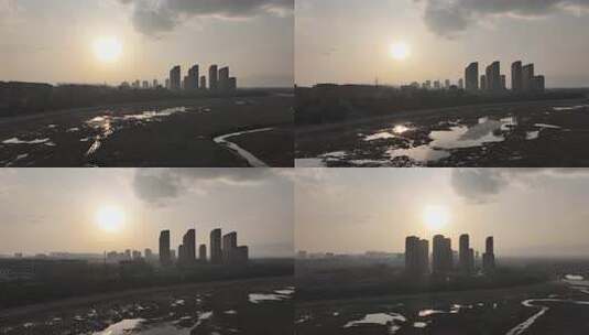 城市夕阳下的高楼与湿地景观高清在线视频素材下载