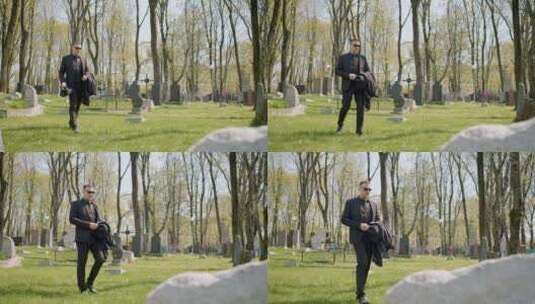 走在墓地里的悲伤男人高清在线视频素材下载