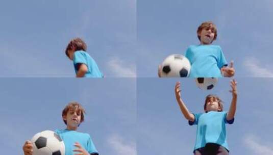 小男孩抱着足球在蓝天下跳跃高清在线视频素材下载