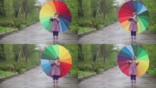 女孩在公园小路上转动彩虹雨伞高清在线视频素材下载