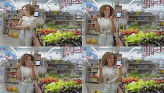 女孩在超市水果区挑选新鲜的水果高清在线视频素材下载