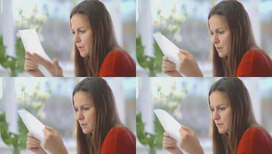 女人皱着眉头阅读信件高清在线视频素材下载