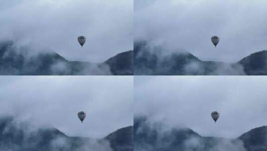 飞在云雾缭绕群山之中的热气球高清在线视频素材下载
