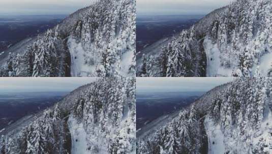 一辆汽车在积雪的山坡上行驶的空中冬景高清在线视频素材下载