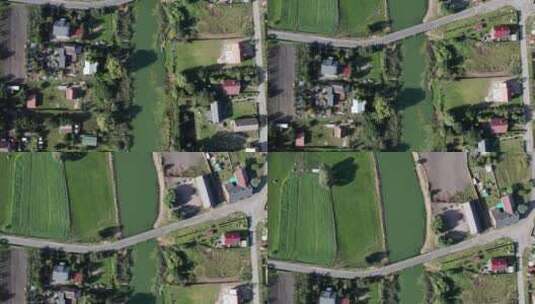 空中自上而下拍摄的一条弯曲的河流流经一个小村庄的田野、农场和花园高清在线视频素材下载