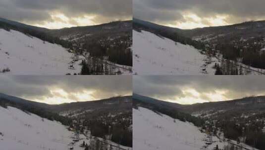 覆盖着雪的村庄和森林鸟瞰高清在线视频素材下载